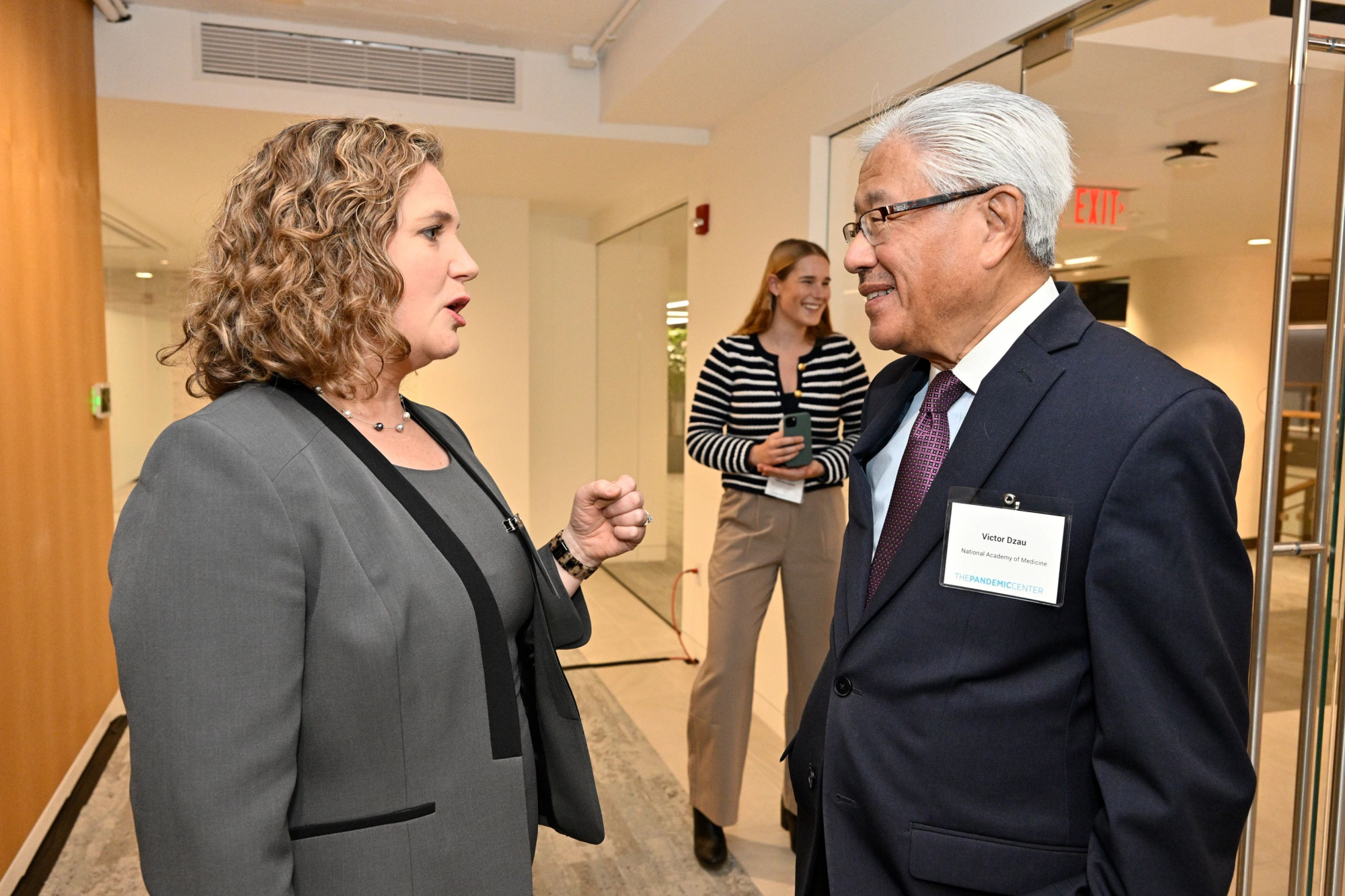 woman speaks to a man at a business event