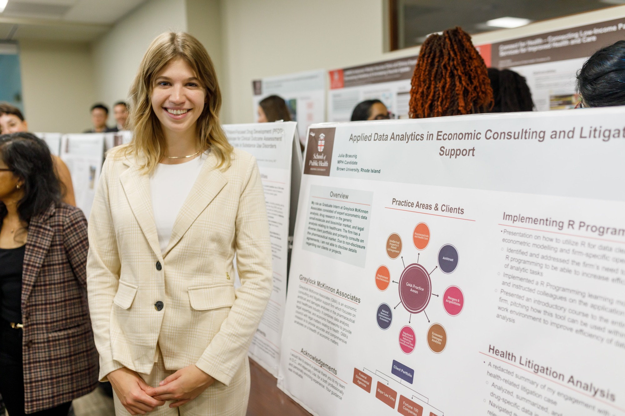 woman standing next to scientific poster