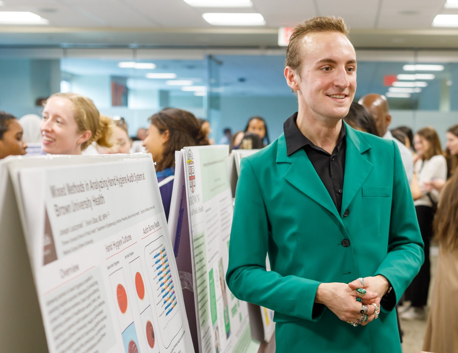 man standing next to scientific poster