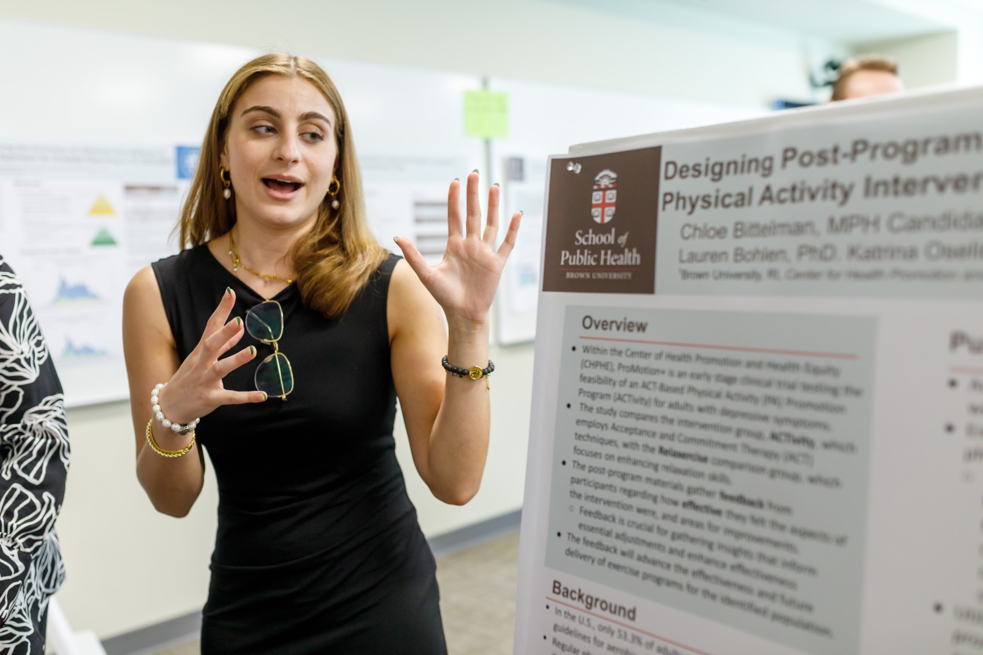 woman presents scientific poster