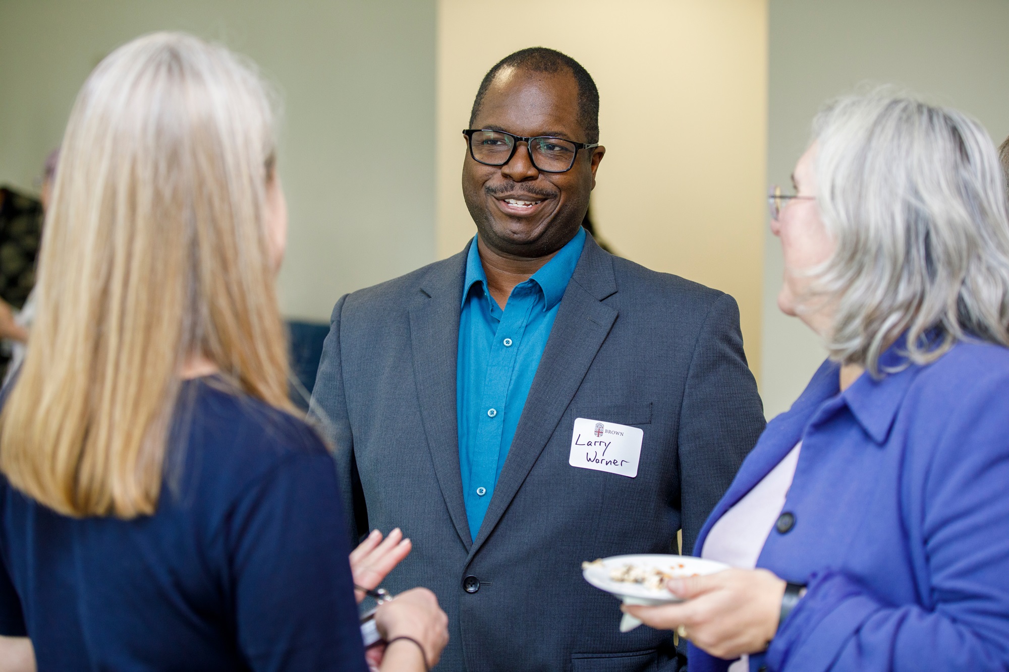 Larry Warner chats with Brown SPH faculty at an event