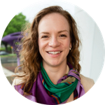 Lizzy Hazeltine, wearing a colorful scarf, smiles at the camea