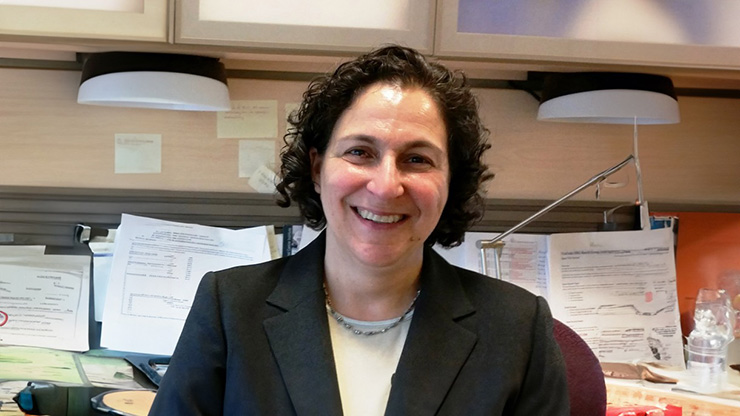 Brown professor smiles