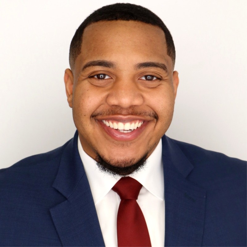 Smiling headshot of Malek Mitchell.