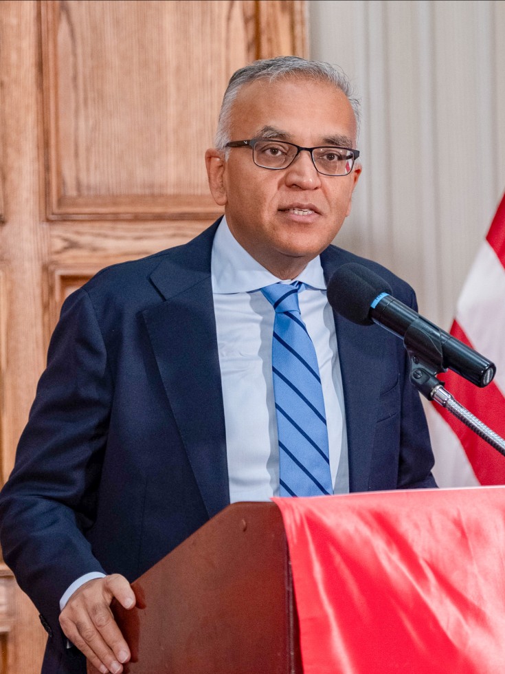 Jha at podium