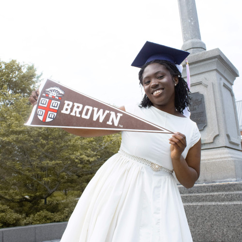 Akinkunmi posing with pennant