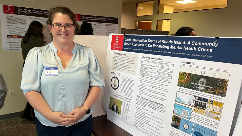woman stands in front of academic poster