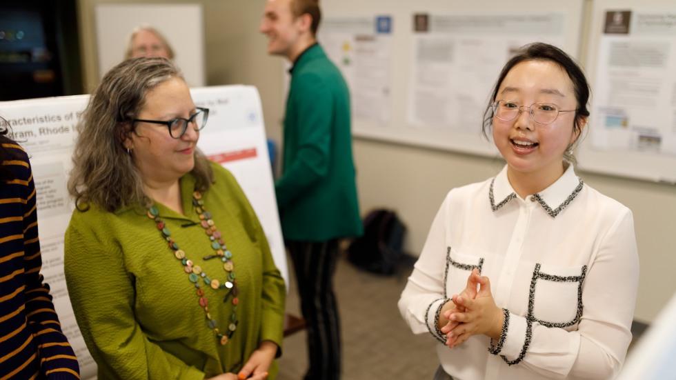 people talking at a poster presentation