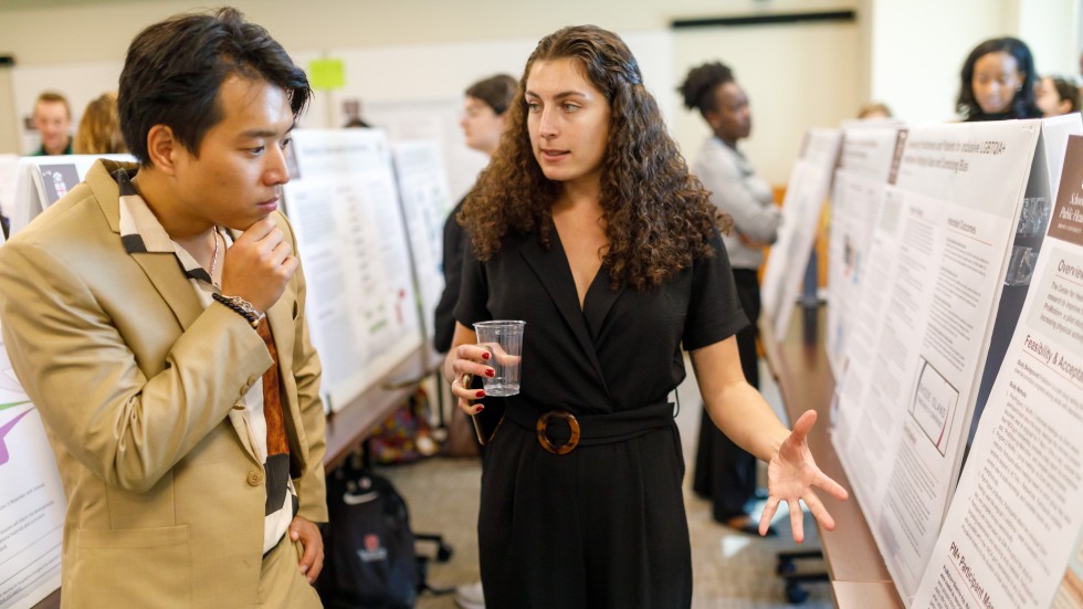 Woman explaining poster to viewer