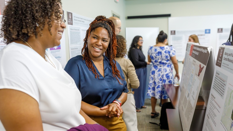 people talking at a poster presentation