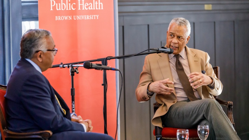 men sitting on stage talking
