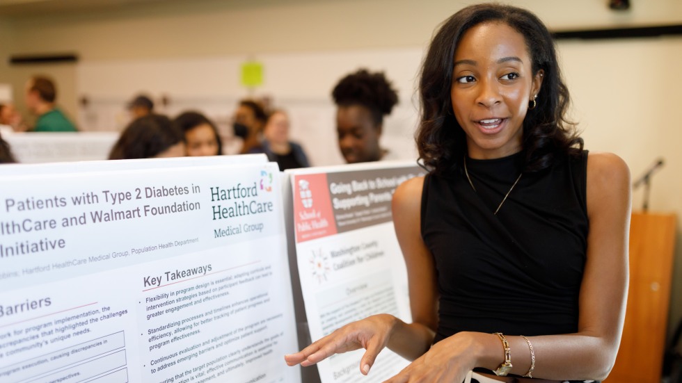 woman presents scientific poster