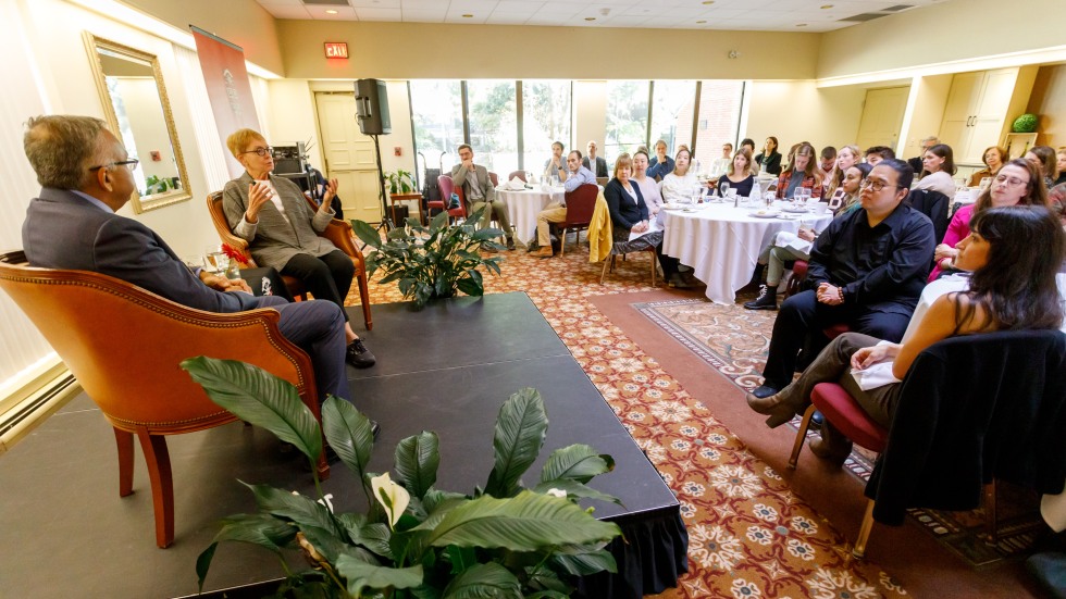 people on stage talking in front of an audience