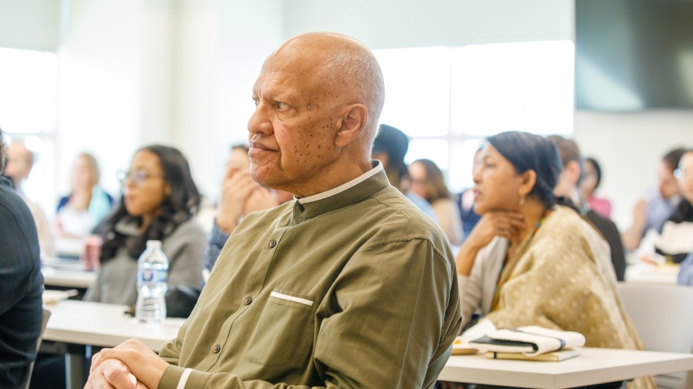man in audience listening to discussion