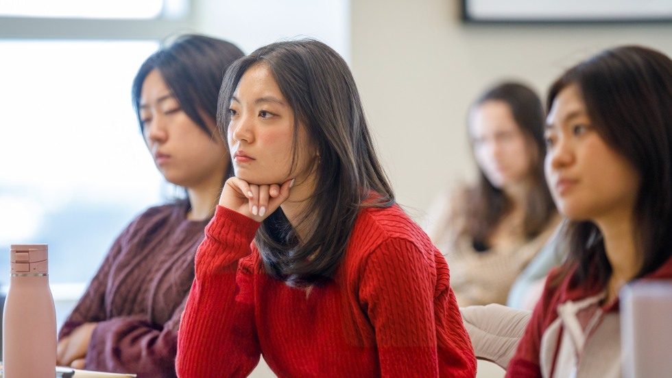 students in audience listening to discussion
