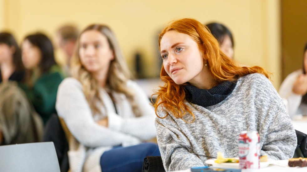 woman in audience listening to speaker