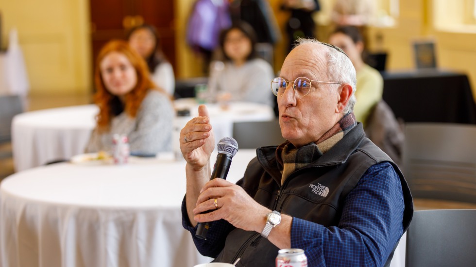 man in audience speaking into microphone
