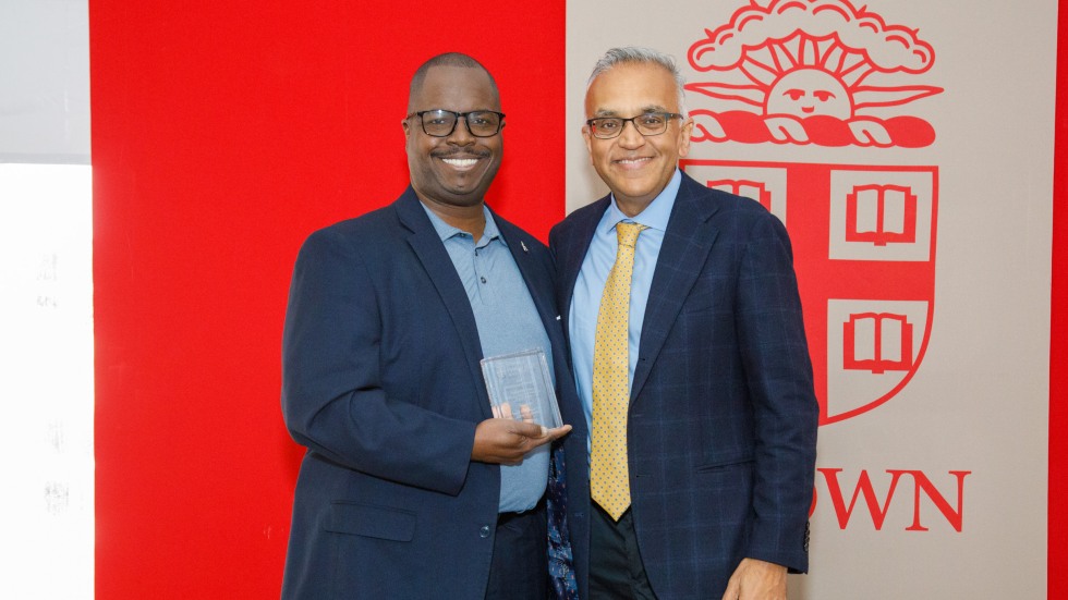 Award winner stands with dean