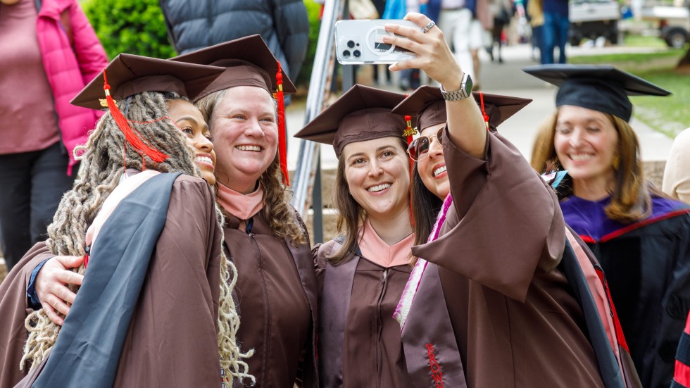four graduates posing for a photo
