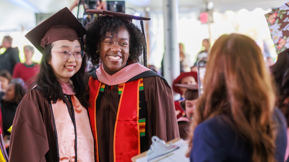 Two smiling graduates