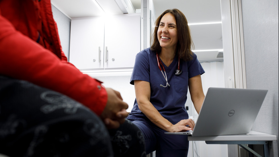 Beaudoin on a laptop in a clinic