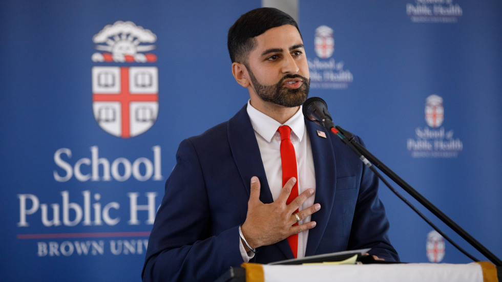 Arvin Singh, secretary of health for the State of West Virginia, speaks at a microphone with a blue background.